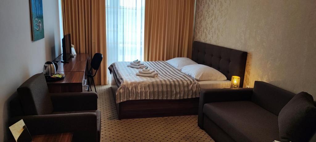 Postel nebo postele na pokoji v ubytování Hotel Merkur