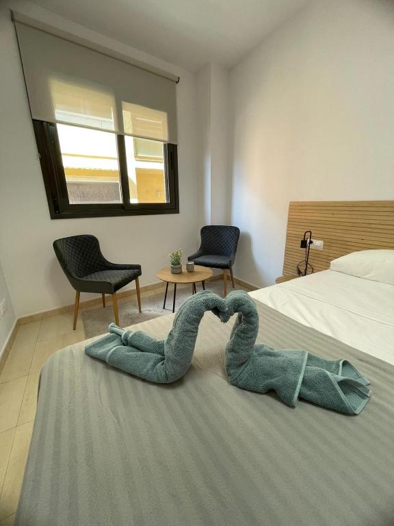 a towel in the shape of a heart on a bed at Apartament Mar Beach Lloret in Lloret de Mar