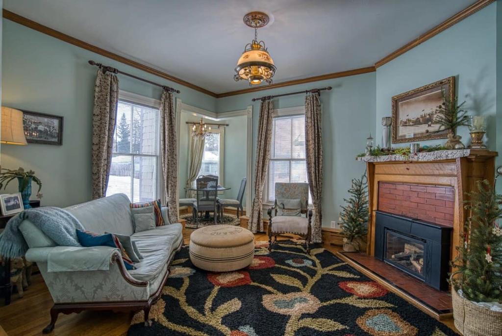 a living room with a couch and a fireplace at The Ice Palace in Leadville