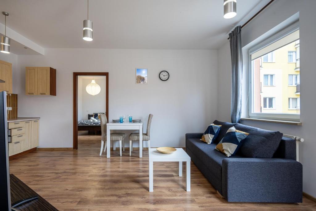 a living room with a couch and a table at 32 Gdynia Oksywie - Apartament Mieszkanie dla 4 os in Gdynia
