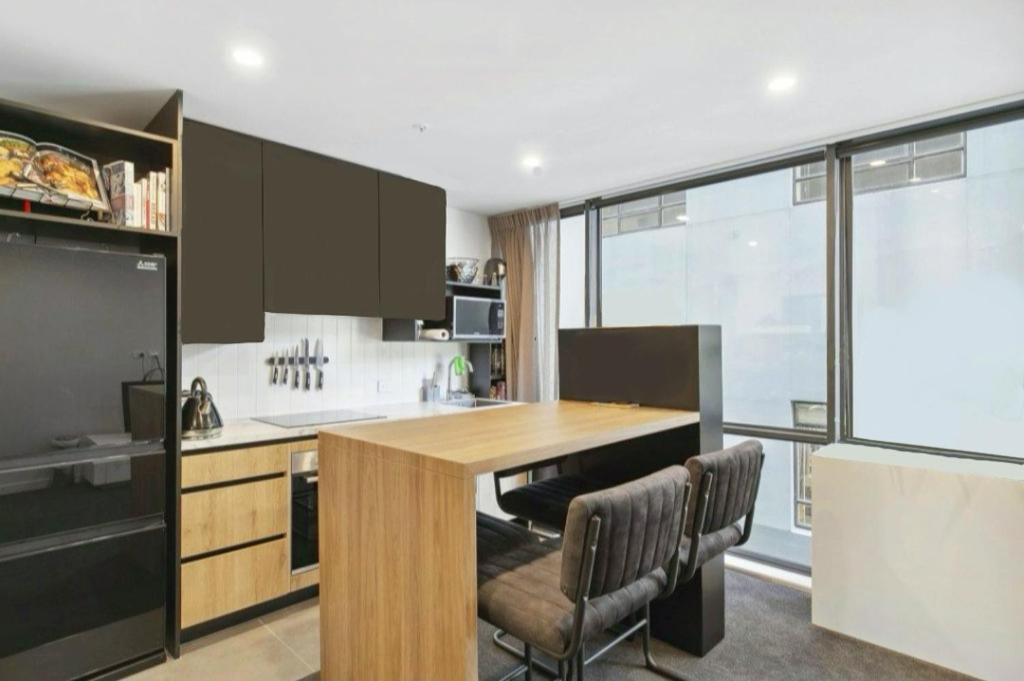 a kitchen with a wooden table and some chairs at 2023 Stylish Central Apt+ Free Parking in Wellington