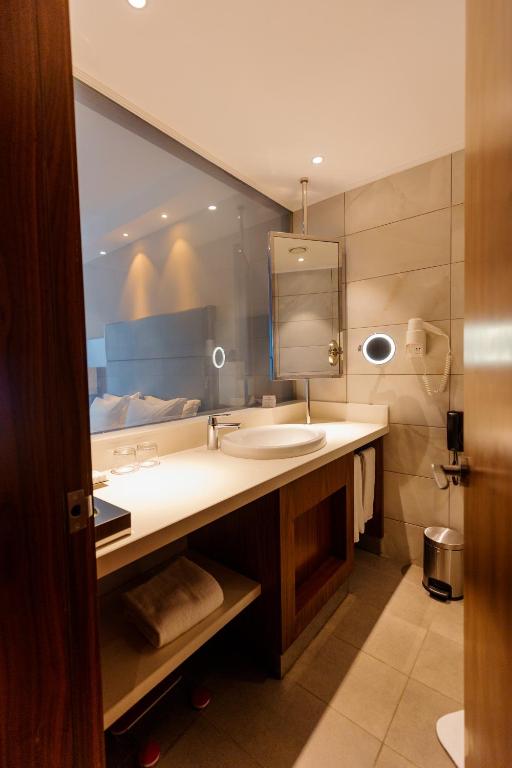 a bathroom with a sink and a mirror at Crowne Plaza Nairobi Airport by IHG in Nairobi