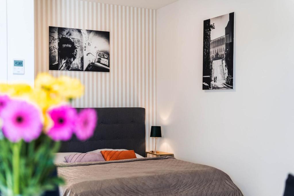 a bedroom with a bed and two pictures on the wall at Silvie Apartments - Wolkerova in Olomouc
