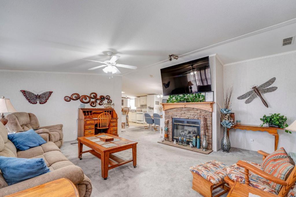 a living room with a couch and a fireplace at 3 bed 2 bath with office room-with futon bed on Weiss Lake - with community ramp & dock in Centre