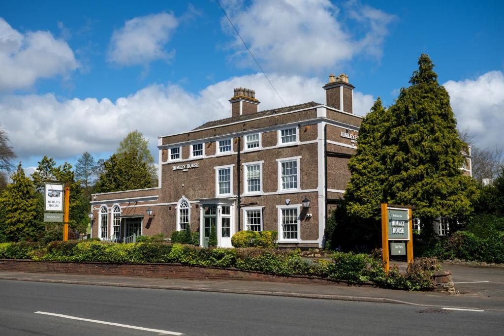 a large brick building on the side of a street at Himley House by Chef & Brewer Collection in Himley