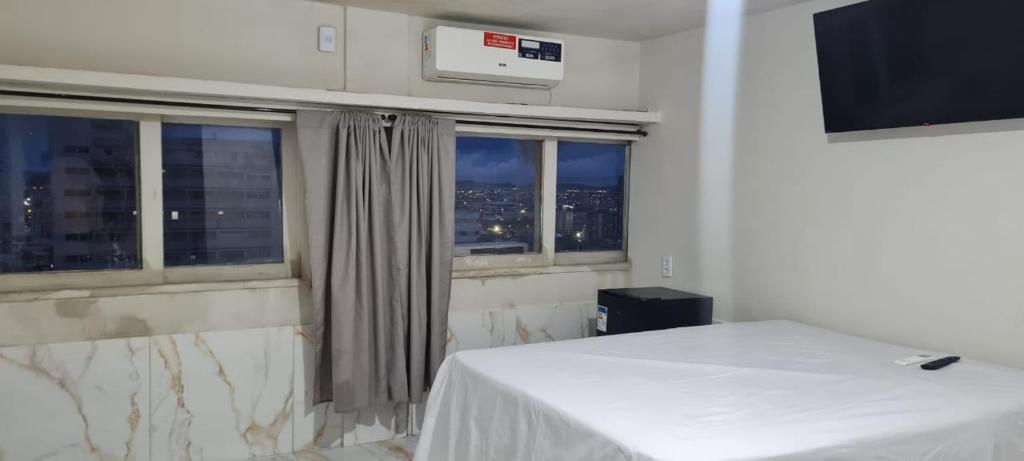 a bedroom with a bed and a window with a view at AP CENTRAL VIP in Campina Grande