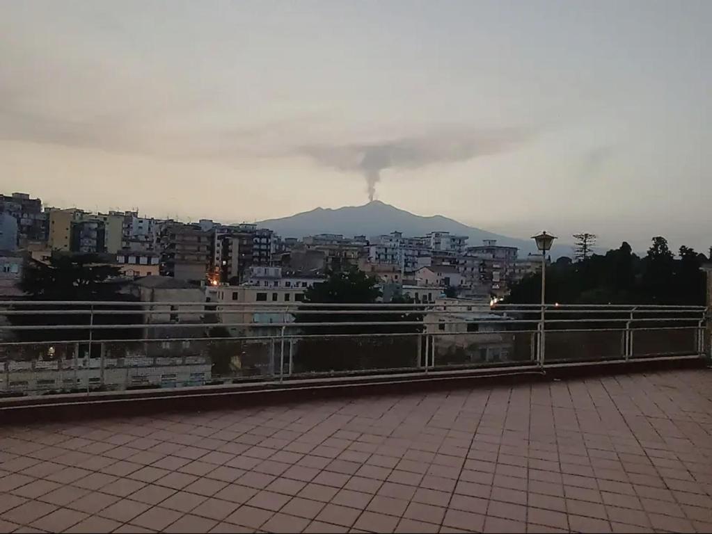 a view of a mountain in the distance from a city at Attico in città con terrazza vista etna mare in Acireale