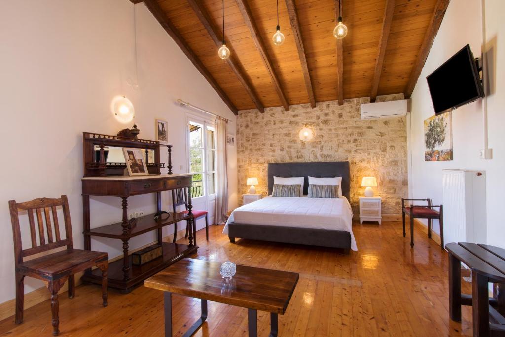 1 dormitorio con 1 cama, mesa y sillas en Grand Skylight, en Corfú
