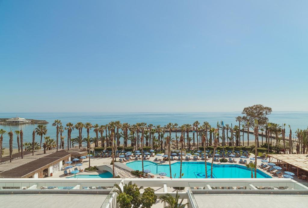 an aerial view of a resort with pools and palm trees at The GrandResort - Limited Edition by Leonardo Hotels in Limassol