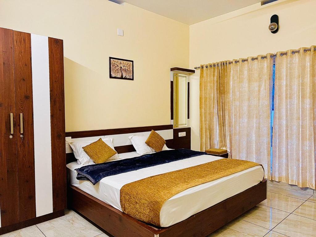 a bedroom with a large bed in a room at DREAM NEST POOL VILLAS in Wayanad