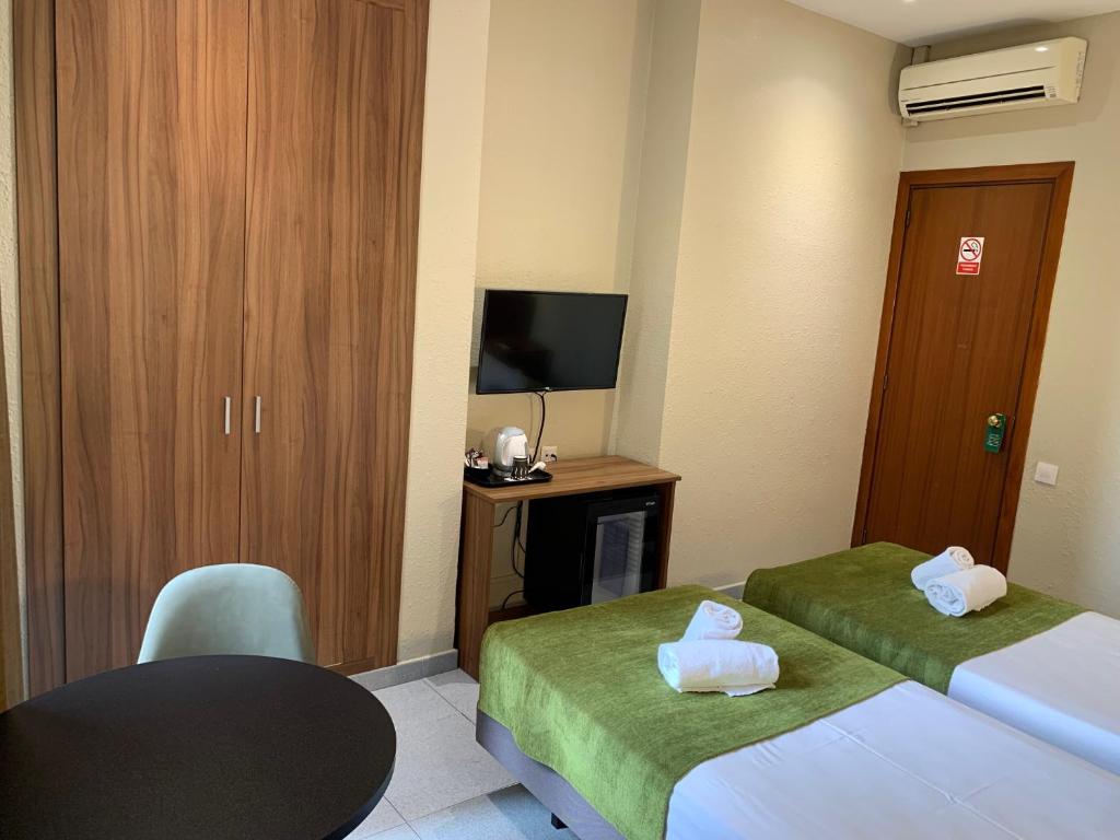 Postel nebo postele na pokoji v ubytování Hotel Aneto