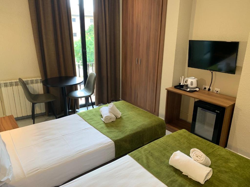 Postel nebo postele na pokoji v ubytování Hotel Aneto