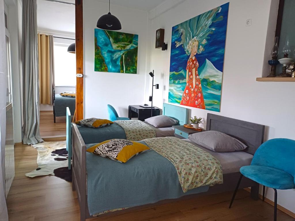 a bedroom with a bed and a painting on the wall at Apartment with Terrace Nona Pavla in Tolmin