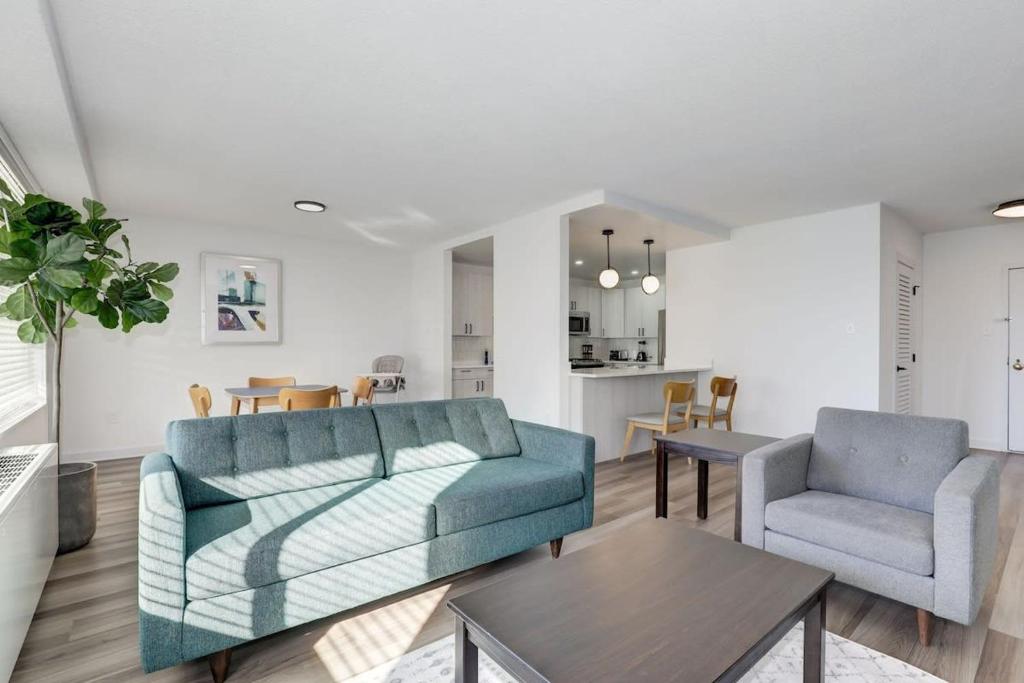a living room with a couch and a chair and a table at Urban Charm: 2BR Modern Retreat Close to Downtown in Arlington