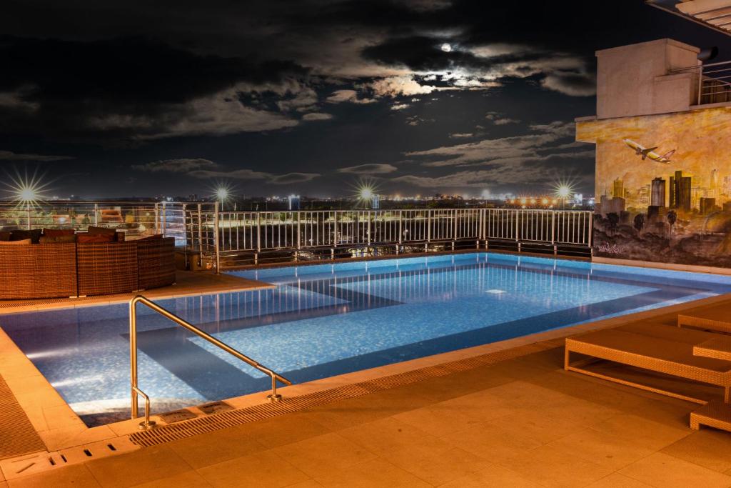 a swimming pool on top of a building at night at Crowne Plaza Nairobi Airport by IHG in Nairobi