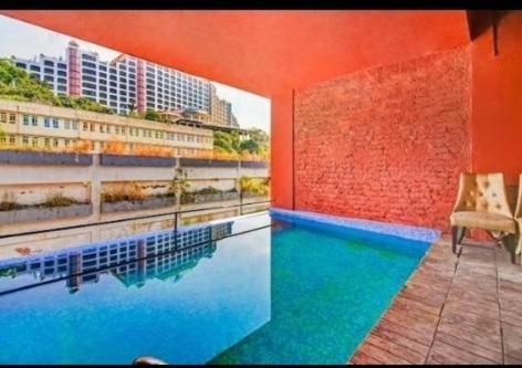 a painting of a swimming pool in a room at Sequence Villa in Mumbai