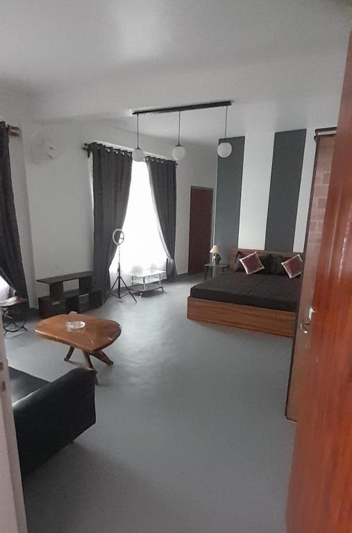 a bedroom with a bed and a table in it at Medajied Guest House in Shillong