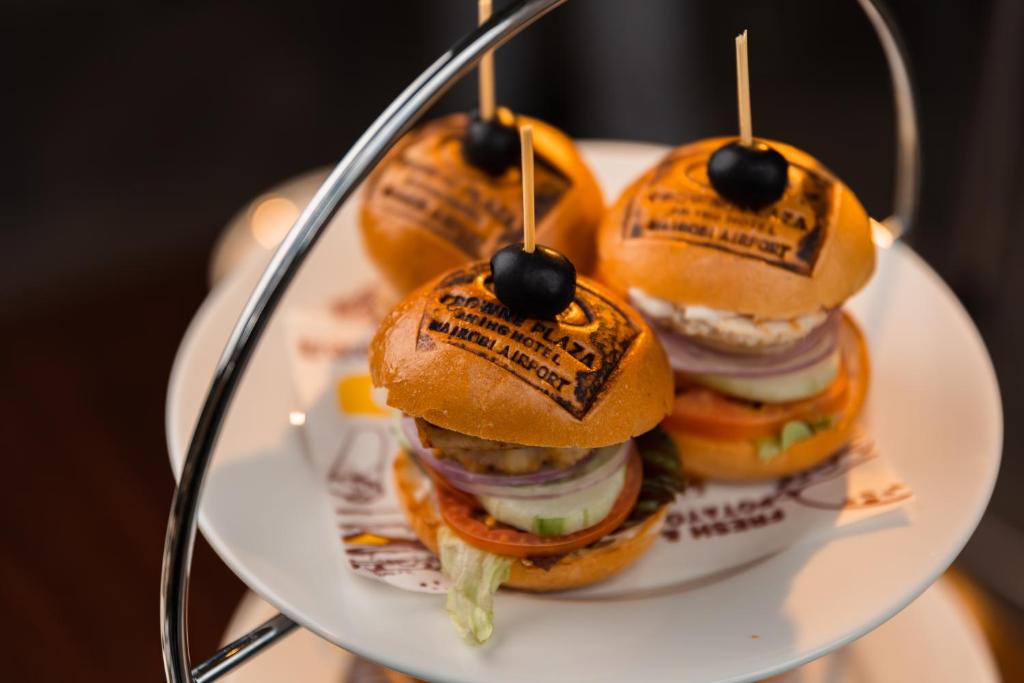 a plate with a bunch of sandwiches on a tray at Crowne Plaza Nairobi Airport by IHG in Nairobi