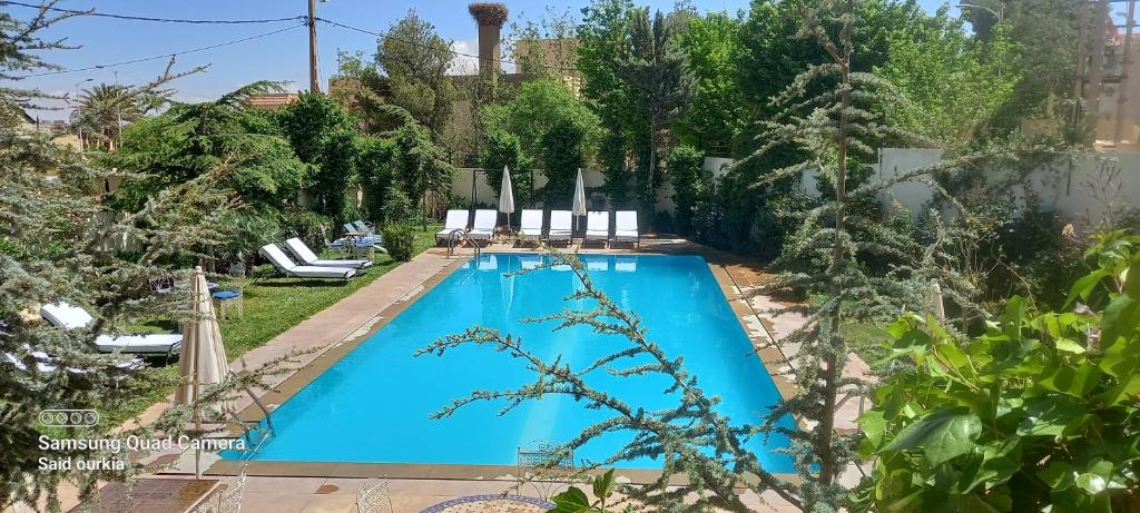 a swimming pool in the backyard of a house at Villa Pomme d'Or in Midelt