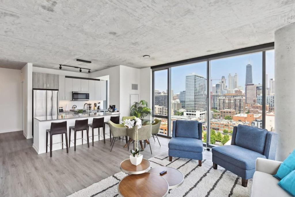 a kitchen and living room with a view of a city at 2BR Luxury River North Apartment With Wonderful Views in Chicago