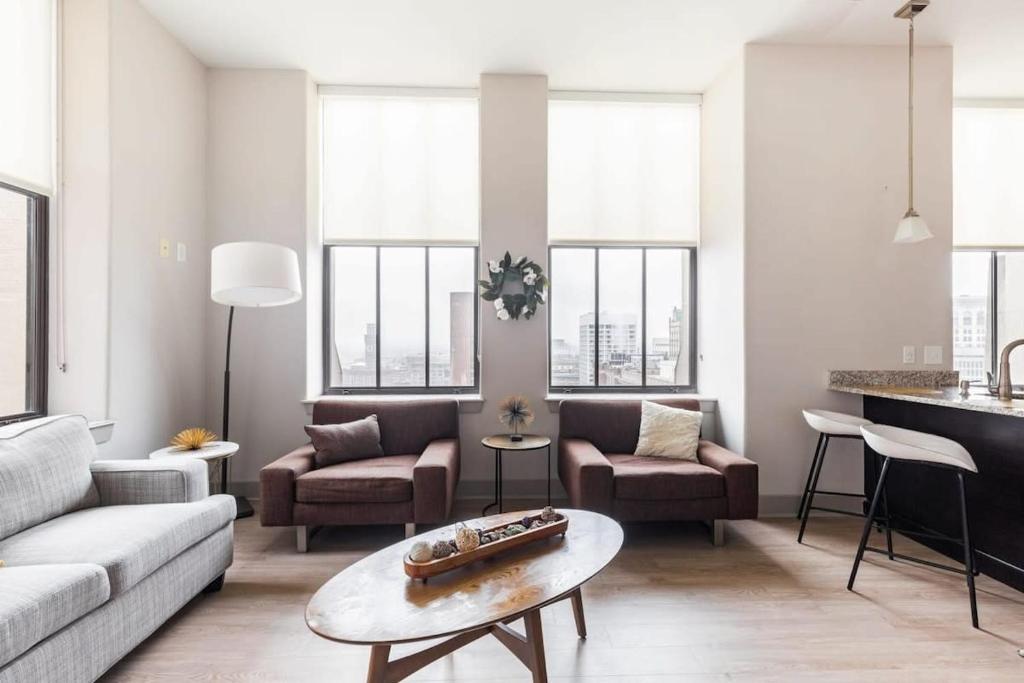 a living room with a couch and a table at 2BR Distinguished Apartment Rooftop Deck & Gym in Baltimore