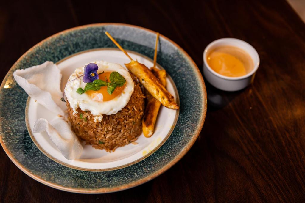 a plate of food with a fried egg and some fries at Crowne Plaza Nairobi Airport by IHG in Nairobi