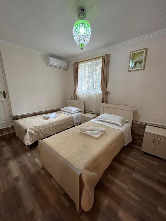 Llit o llits en una habitació de Orchidea Guest House