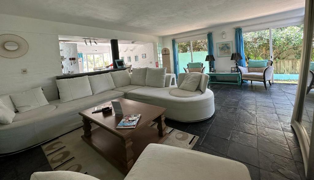 a living room with a white couch and a table at Hotel Donatella mare boutique in Punta del Este