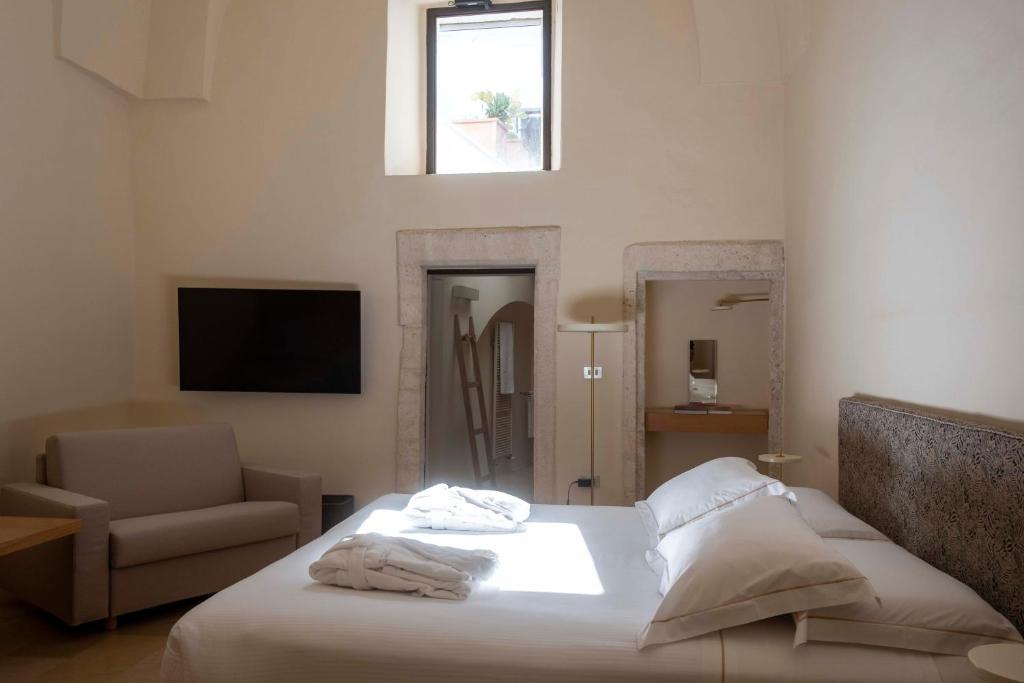 Кровать или кровати в номере La Sommità Relais & Chateaux
