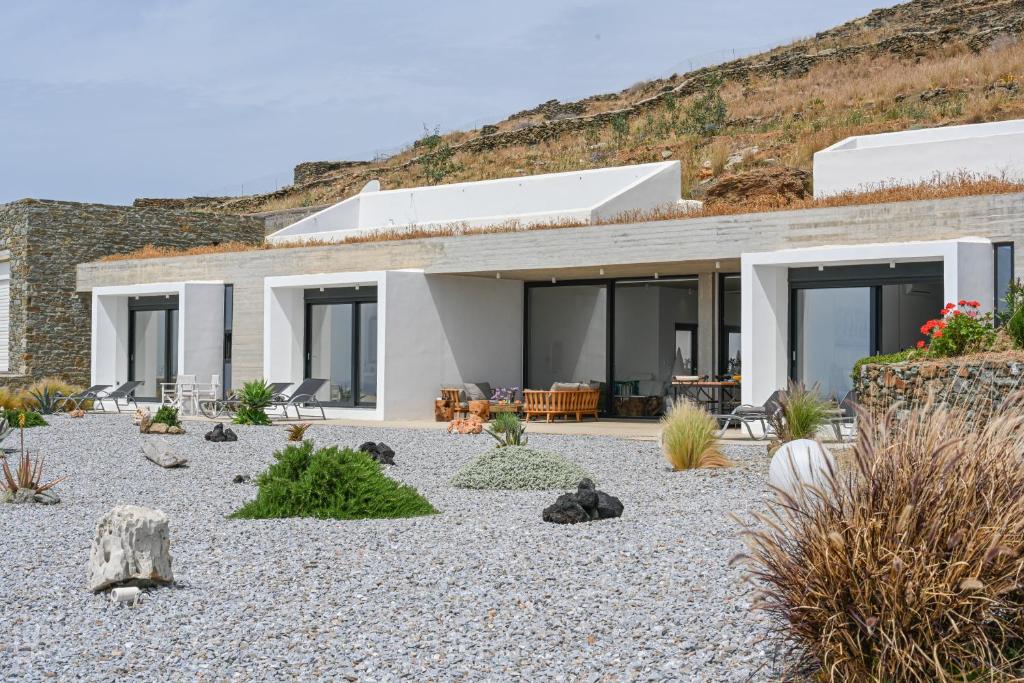 a house on a hill with a gravel yard at Dream Cave Villa Tinos in Tinos Town