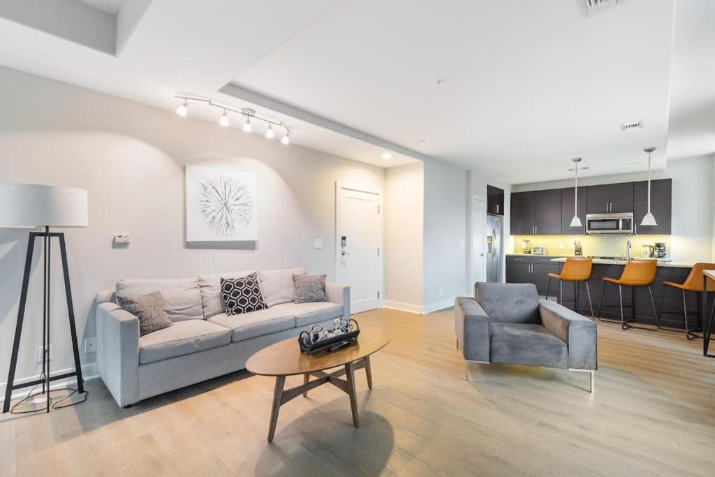 a living room with a couch and a table at 2B 2BA Distinguished Apartment Rooftop Pool & Gym in Baltimore