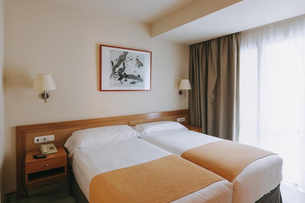 a hotel room with a bed and a window at Hotel Zaragoza Plaza in Donostia-San Sebastián