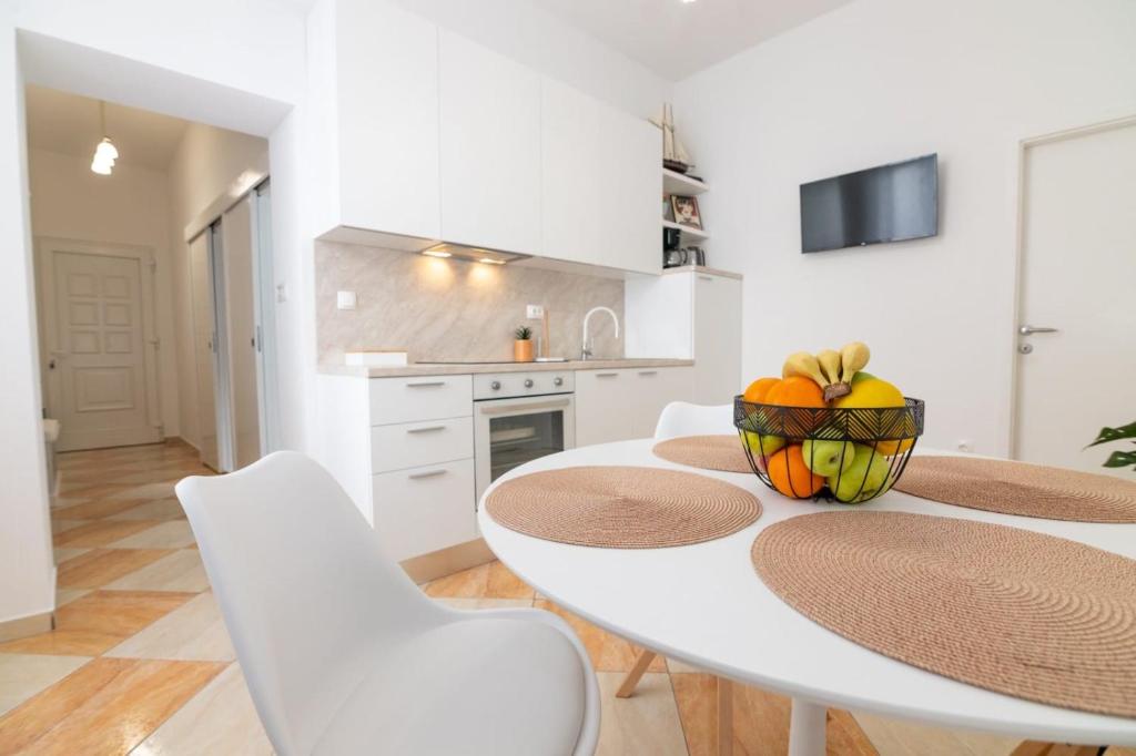 a kitchen and dining room with a table and chairs at Teatro apartment in Rijeka