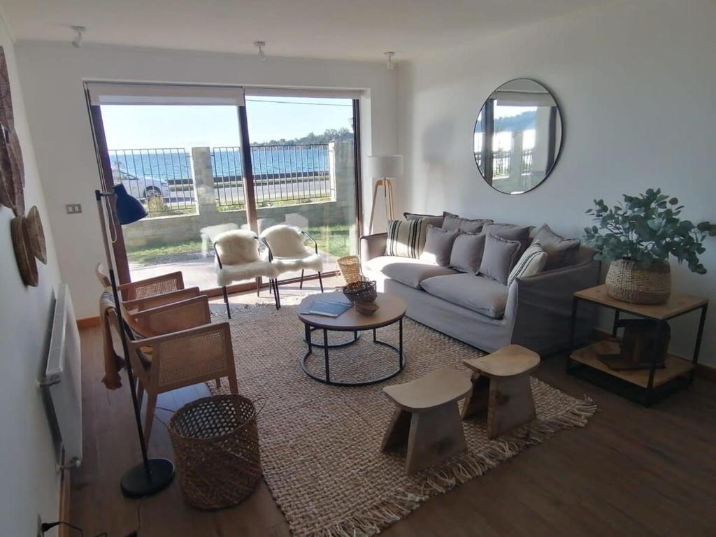 a living room with a couch and a table at NUEVO y acogedor Dpto en PuertoVaras 4Pax Parking Servicio HOM in Puerto Varas