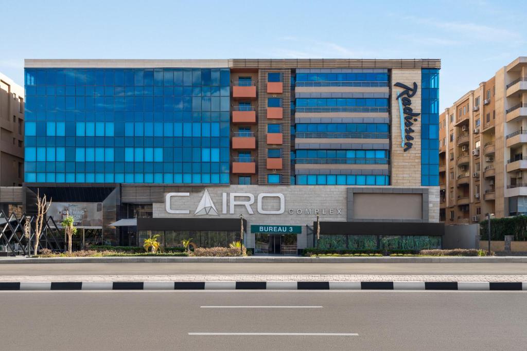a building with a carmo sign in front of it at Radisson Residences Cairo Heliopolis in Cairo