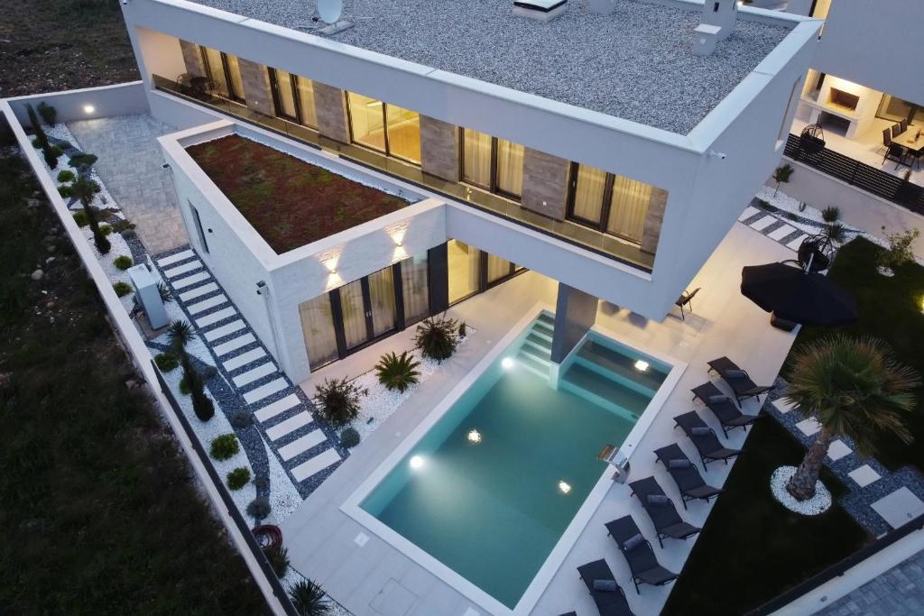 an aerial view of a house with a swimming pool at Villa Didov San Family Residence with Pool in Zaton