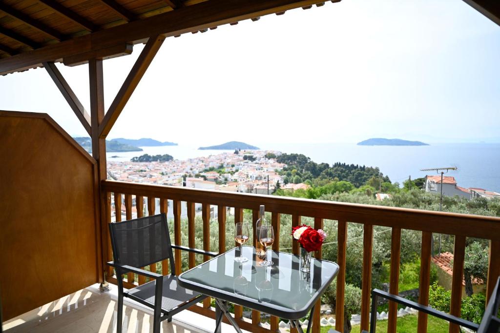a table on a balcony with a view of the ocean at Makis Sea View Studios in Skiathos Town