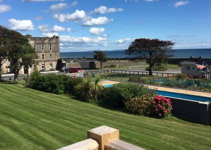 a view of a building and a swimming pool at Amroth Castle Holiday Park in Amroth