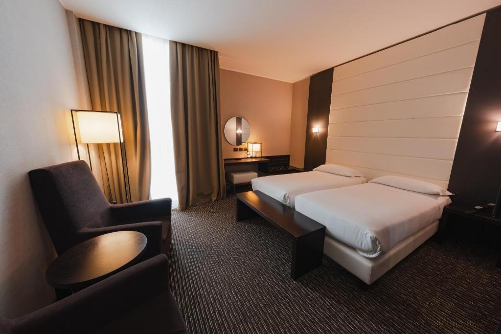 Postel nebo postele na pokoji v ubytování H2C Hotel Milanofiori