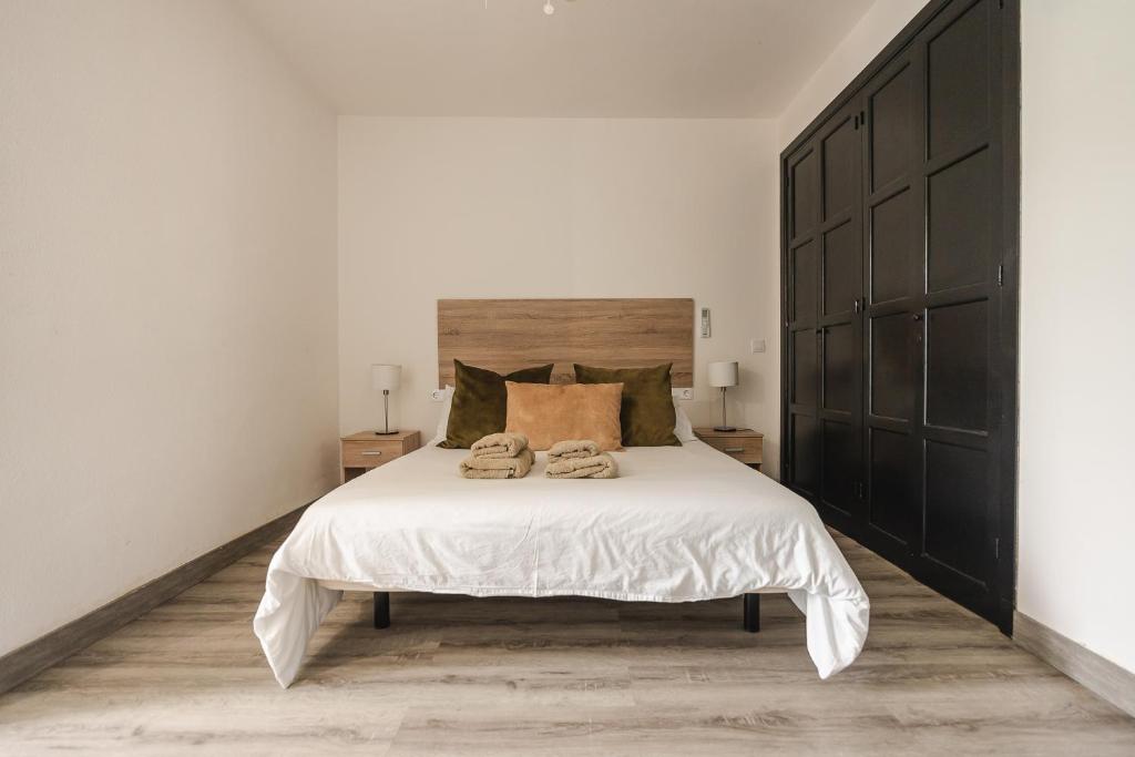 a bedroom with a large bed with two towels on it at Los Cardones Boutique Village in Playa de las Americas