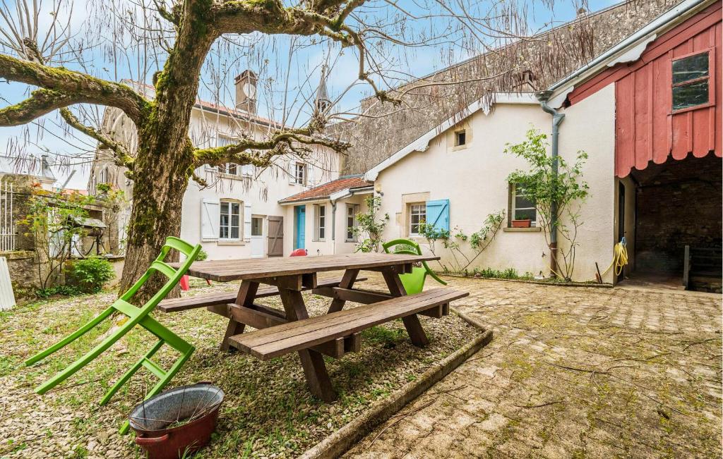 a picnic table and chairs in front of a building at 5 Bedroom Gorgeous Home In Dommartin-le-saint-pr in Dommartin-le-Saint-Père