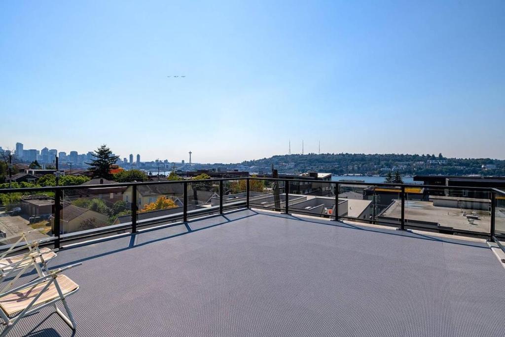 a balcony with chairs and a view of the city at A-Seattle Urban Village- Lopez- Roof top view deck in Seattle