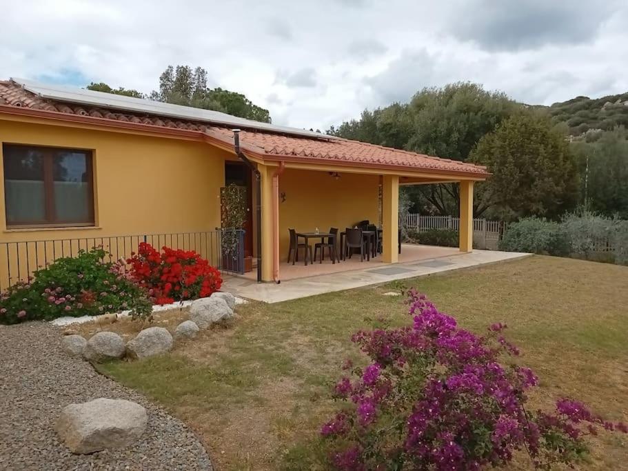 a yellow house with a patio and some flowers at Bisu La Casa dei Sogni IUN R8622 in Capitana