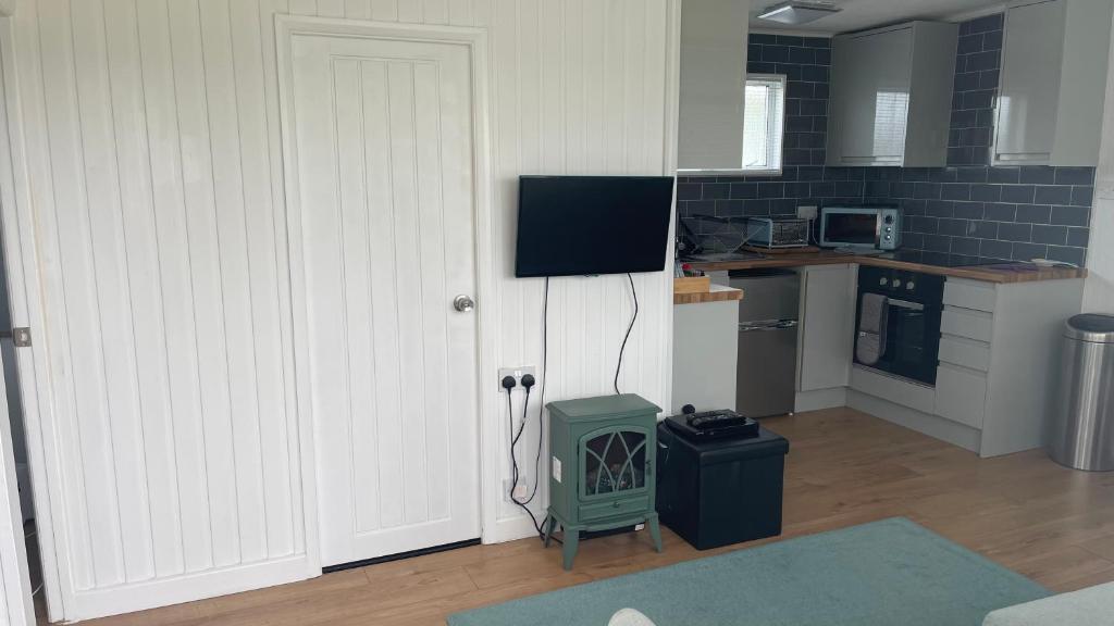 a kitchen with a white door and a stove at 25. Valencia in Selsey