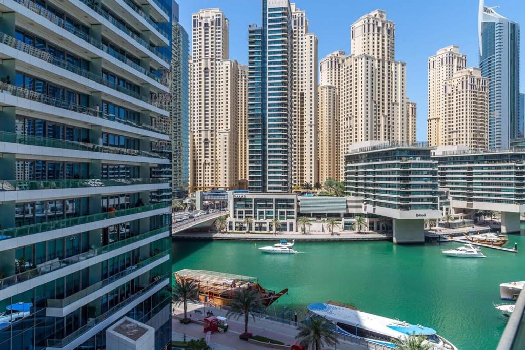 a view of a river in a city with tall buildings at Frank Porter - Silverene in Dubai
