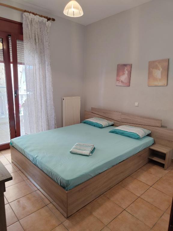 Postel nebo postele na pokoji v ubytování APOSTOLIS APARTMENT