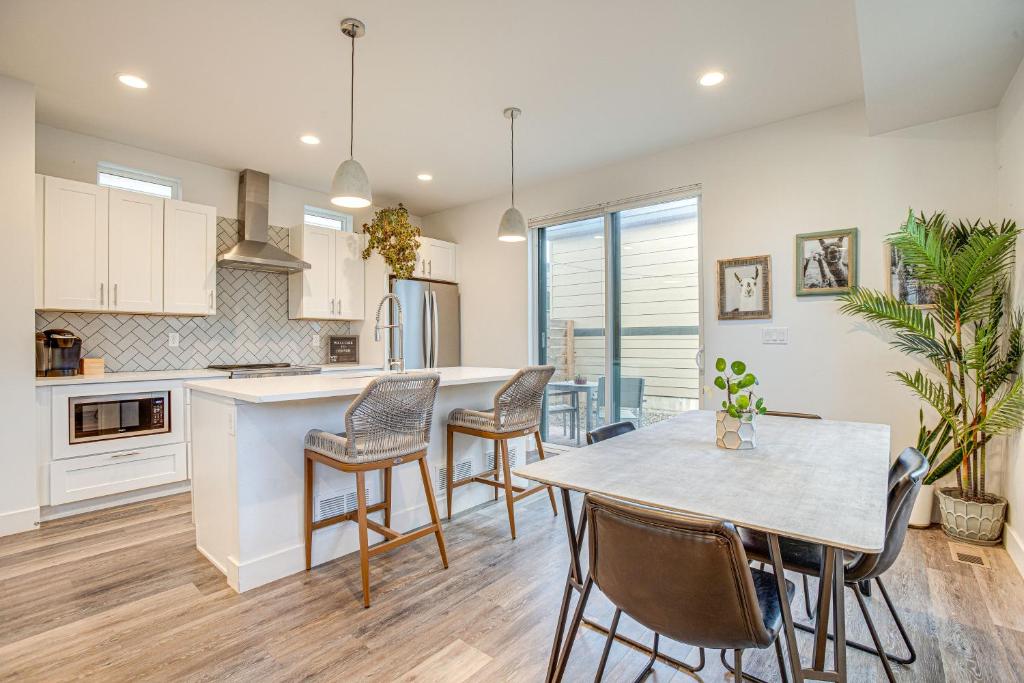 a kitchen and dining room with a table and chairs at Modern Denver Vacation Rental with Rooftop Deck! in Denver