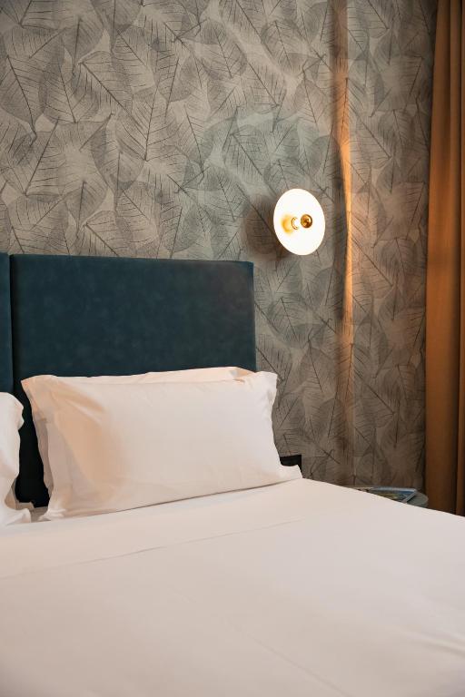 Postel nebo postele na pokoji v ubytování H2C Hotel Milanofiori