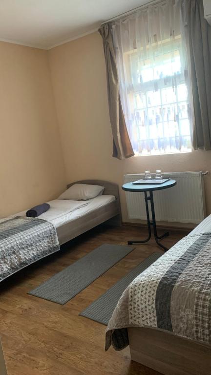 Postel nebo postele na pokoji v ubytování Toscan Panzió