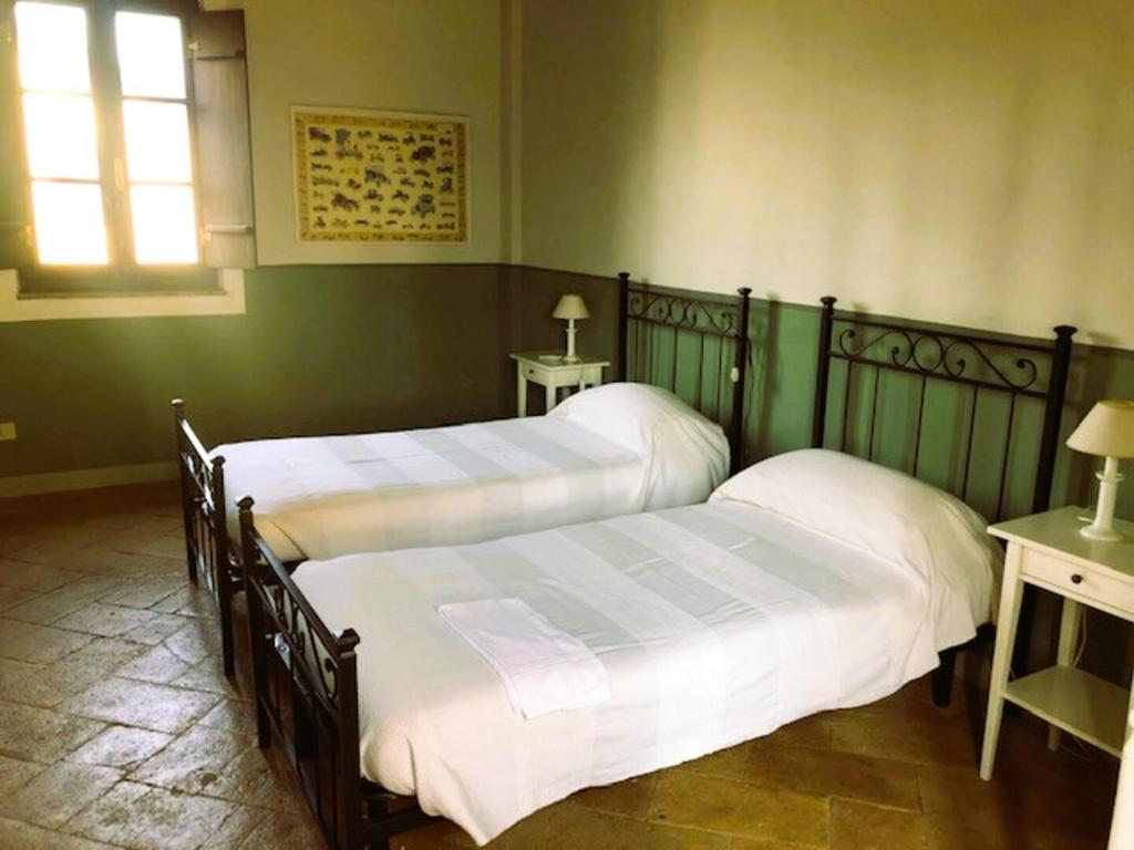 Postel nebo postele na pokoji v ubytování AGRITURISMO LE CORTI DELLA GUALDANA